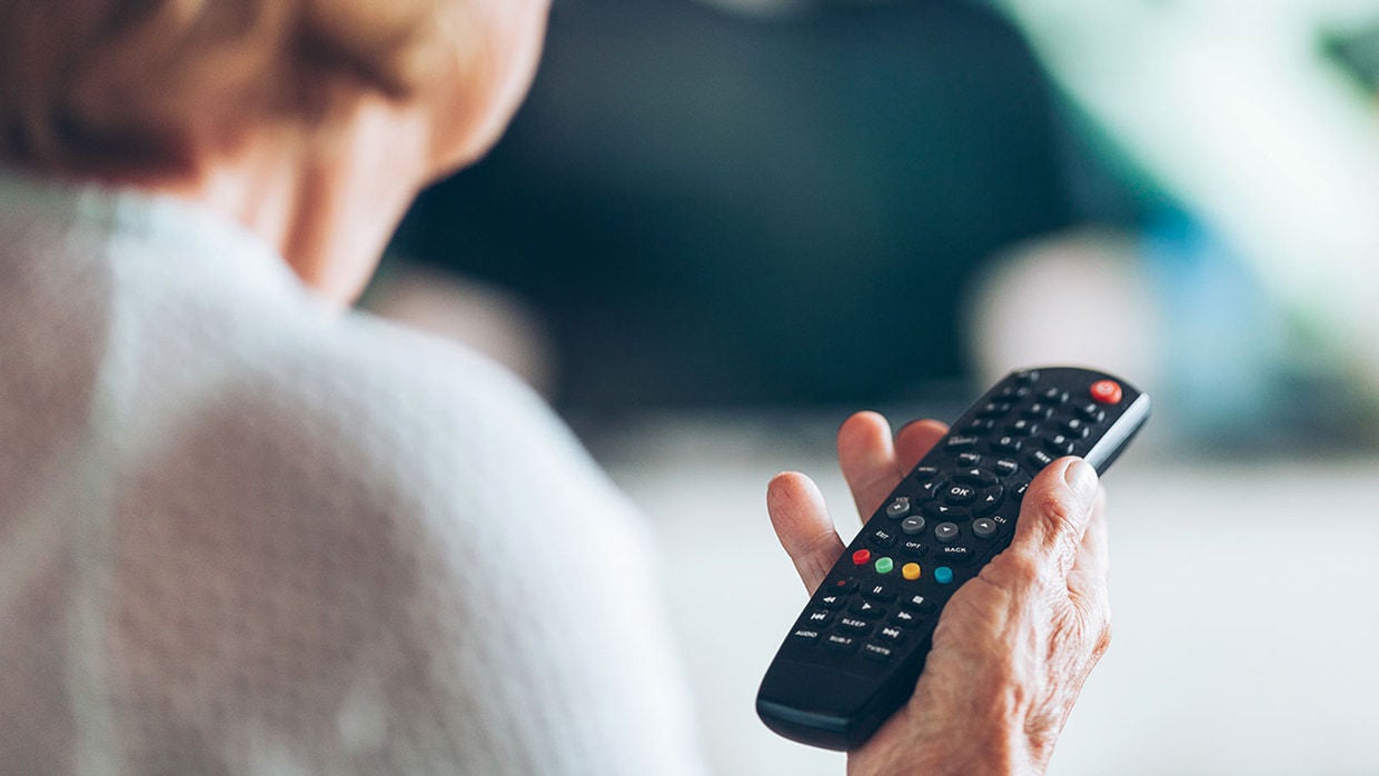 mature woman with tv control