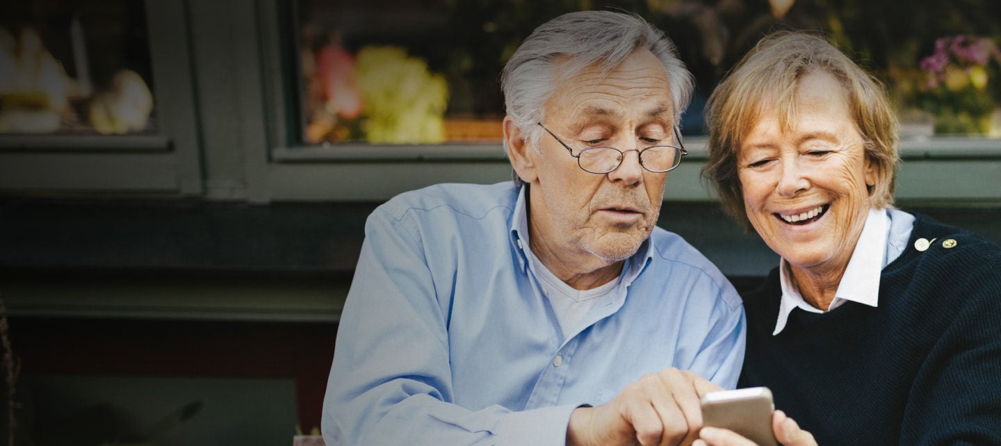 senior couple looking at mobile phone