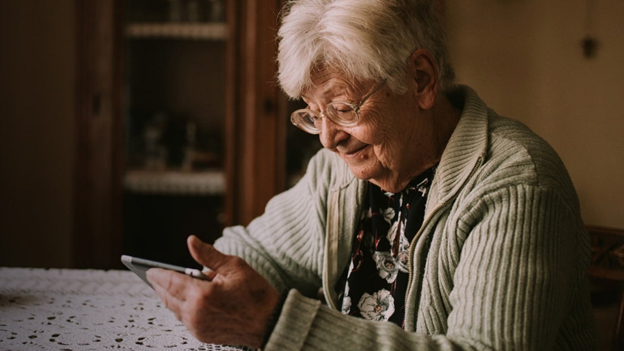 elderly woman using phone at home
