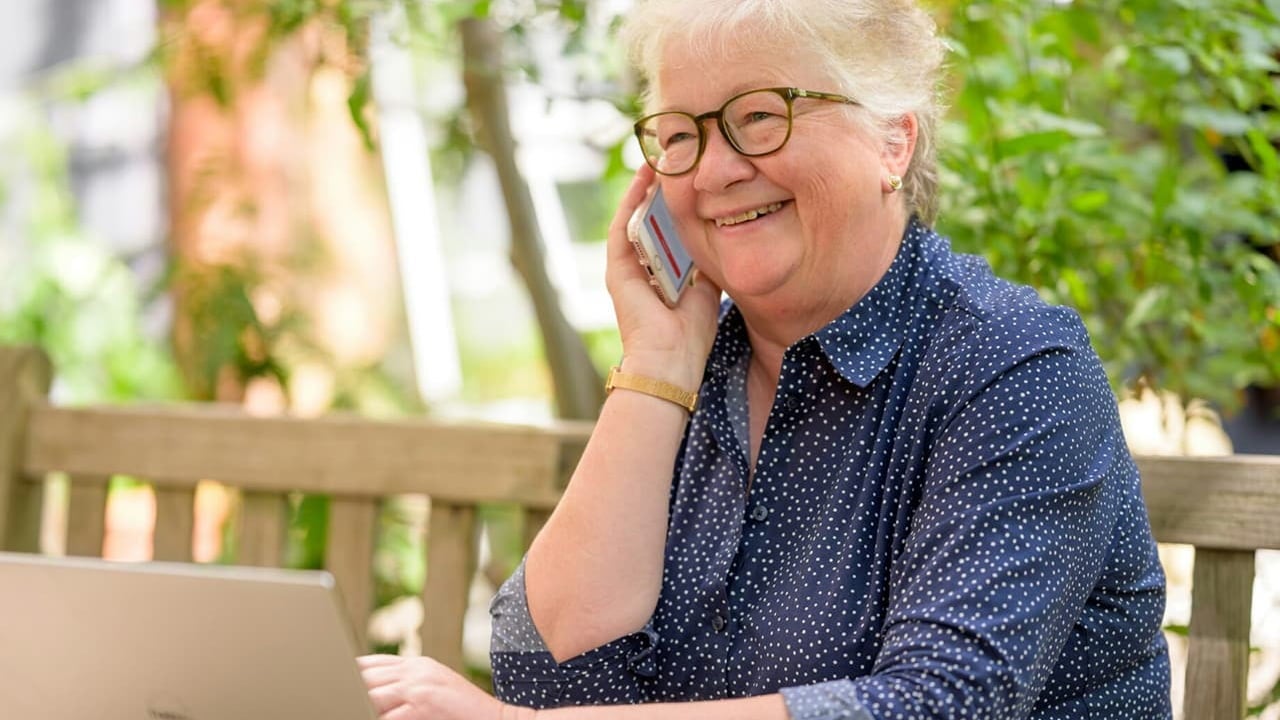 senior woman talking on phone and laptop